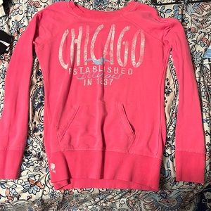 A pink Chicago sweater. Size small.